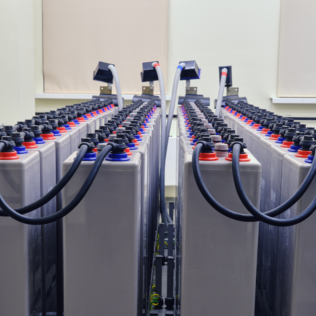Battery management system setup with multiple batteries connected by wires, illustrating energy storage solutions relevant to sustainable energy discussions.
