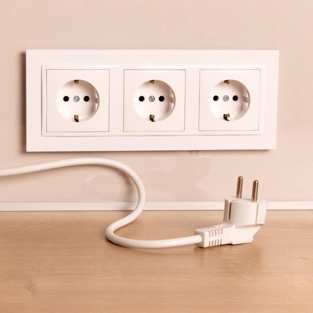 Energy-efficient electrical outlet with a plugged-in power cord, emphasizing sustainable energy use and battery management.